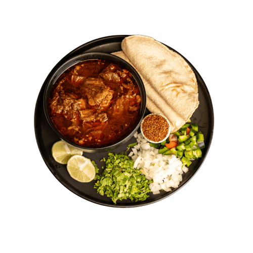 Birria dish with handmade tortillas.