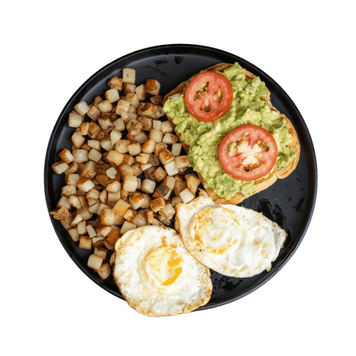Sunny-side-up eggs served with toasted bread, fresh avocado, and golden potatoes.
