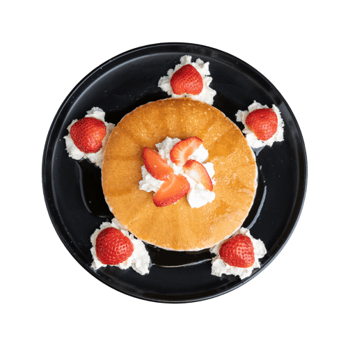 Fluffy pancakes with maple syrup and fresh fruit.