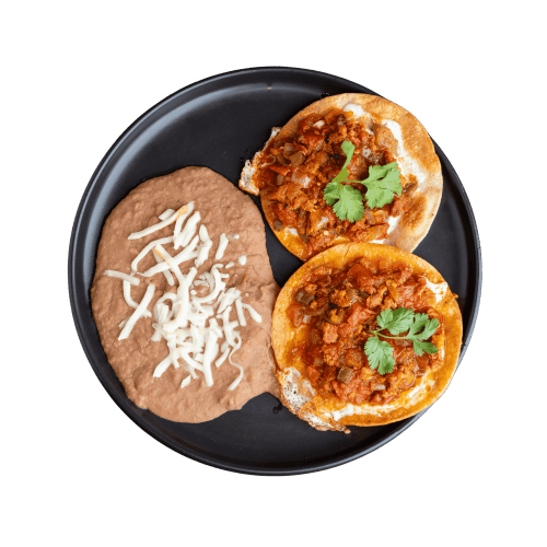 Crispy tostadas spread with refried beans and topped with fresh cheese.